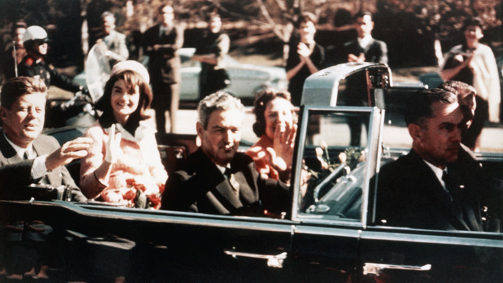  Prior to his assassination, President John F. Kennedy, First Lady Jacqueline Kennedy, and Texas Governor John Connally ride through the streets of Dallas, Texas on November 22, 1963. 