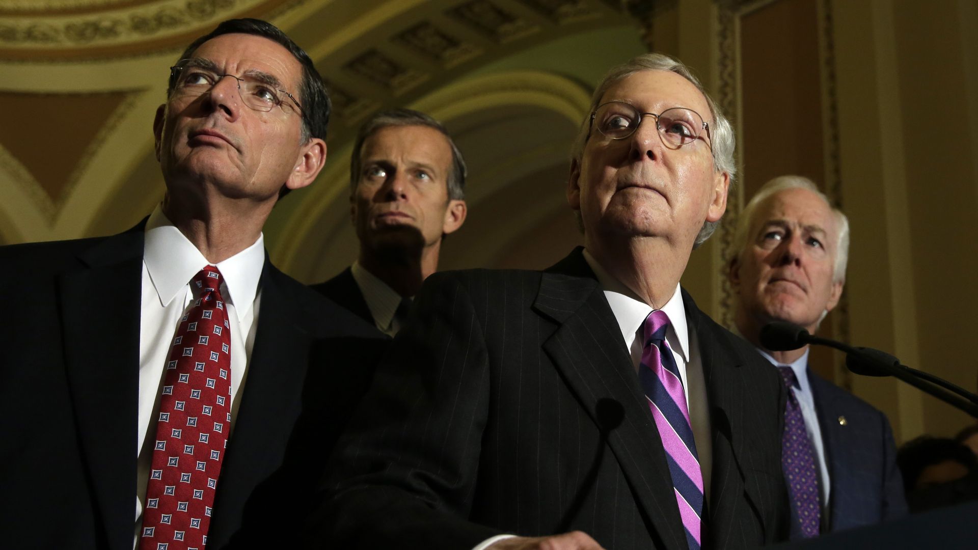 Senate Majority Leader Mitch McConnell (R-KY) (C) listens to questions from the media as Senators John Barrasso(L),R-PA, John Thune(2nd-L), R-SD, and John Cornyn(R), R-TX look on after a policy luncheon on Capitol Hill 