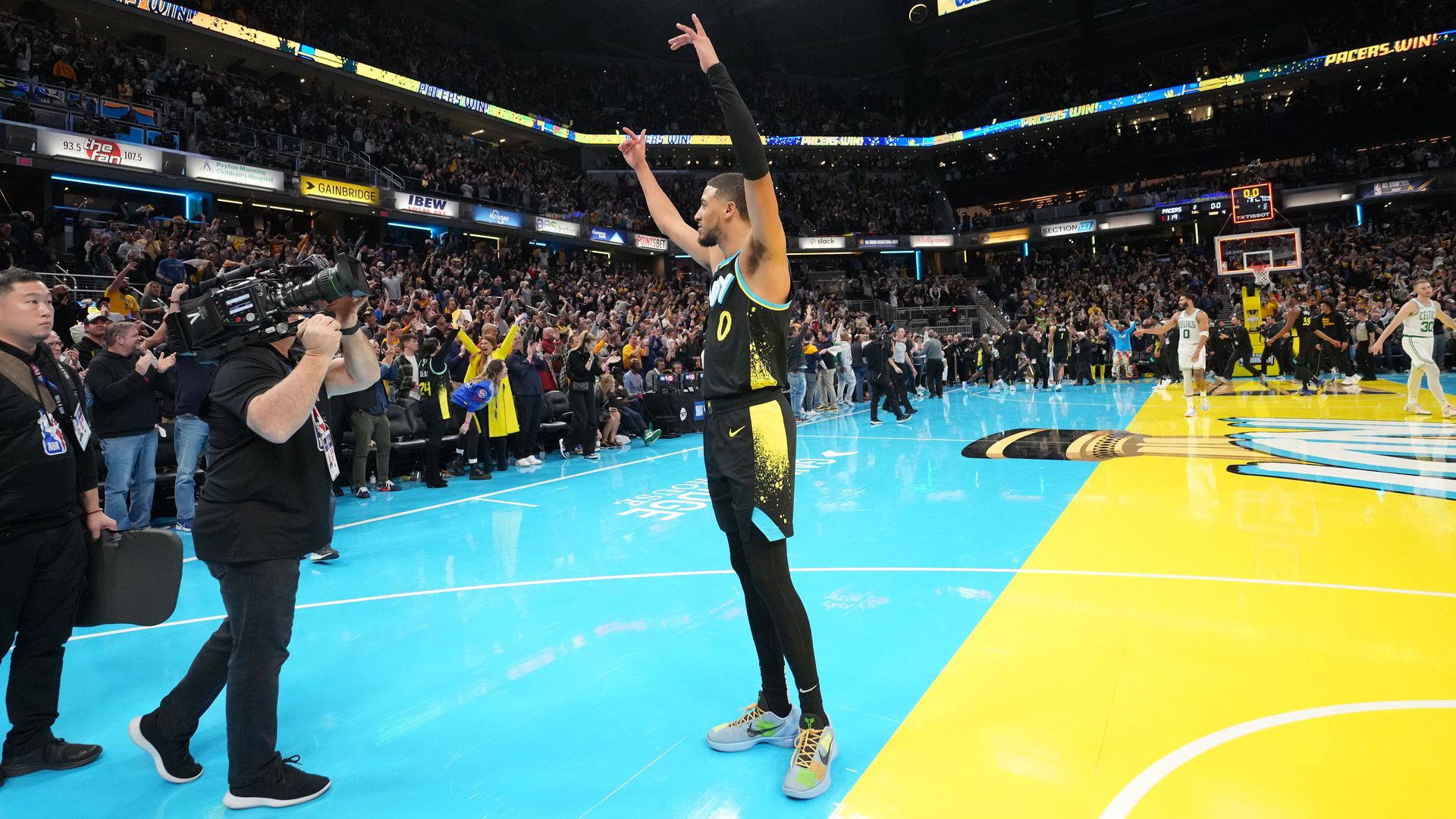 Tyrese Haliburton celebrates with his arms raised after the Pacers beat the Boston Celtics.