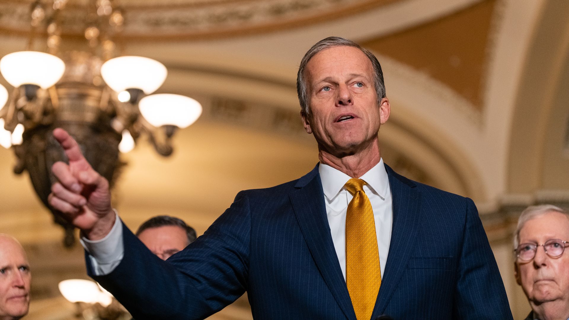 Sen. John Thune is seen speaking with reporters.