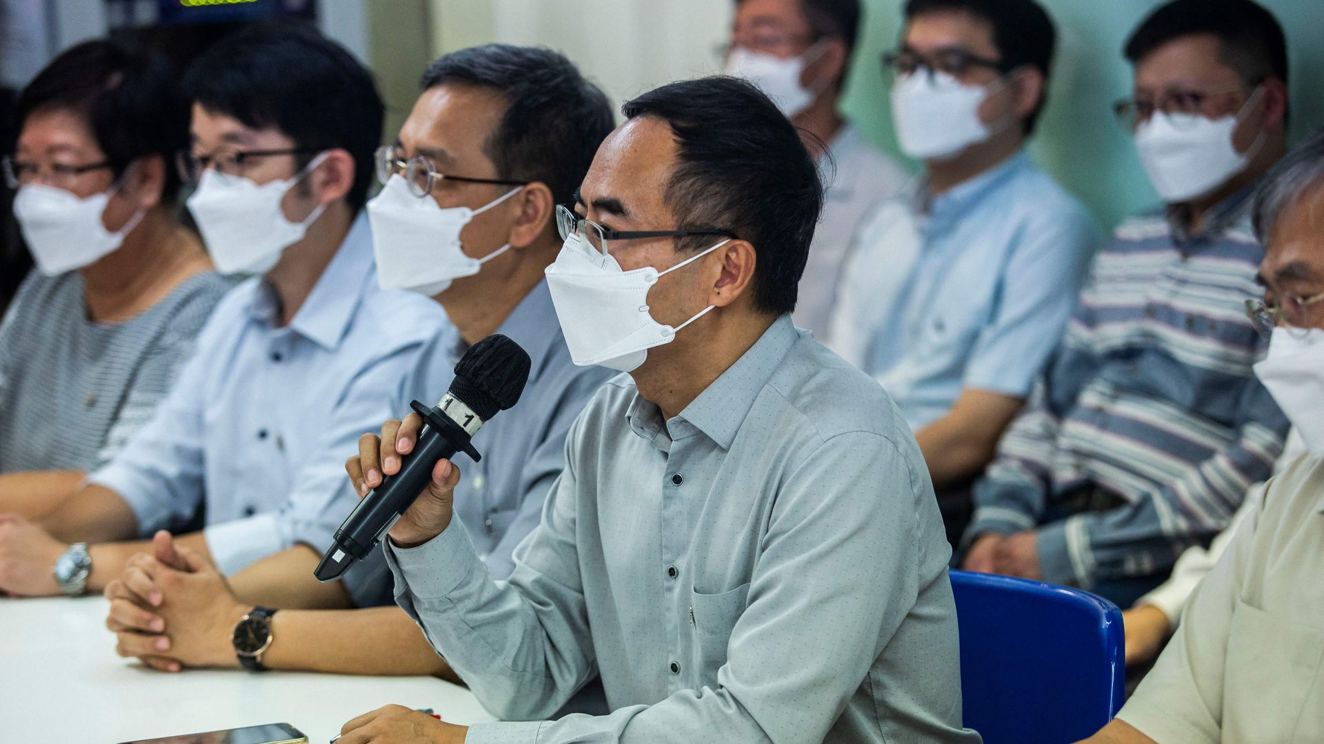 President of the Hong Kong Professional Teachers Union Fung Wai-wah (C) speaks at a press conference in Hong Kong on August 10, 2021, 