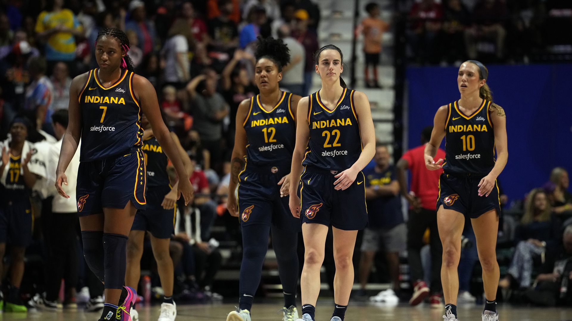 Aliyah Boston #7, Damiris Dantas #12, Caitlin Clark #22 and Lexie Hull #10 of the Indiana Fever take the court against the Connecticut Sun in the first half of a first-round WNBA playoff game at Mohegan Sun Arena on September 22, 2024 in Uncasville, Connecticut. 