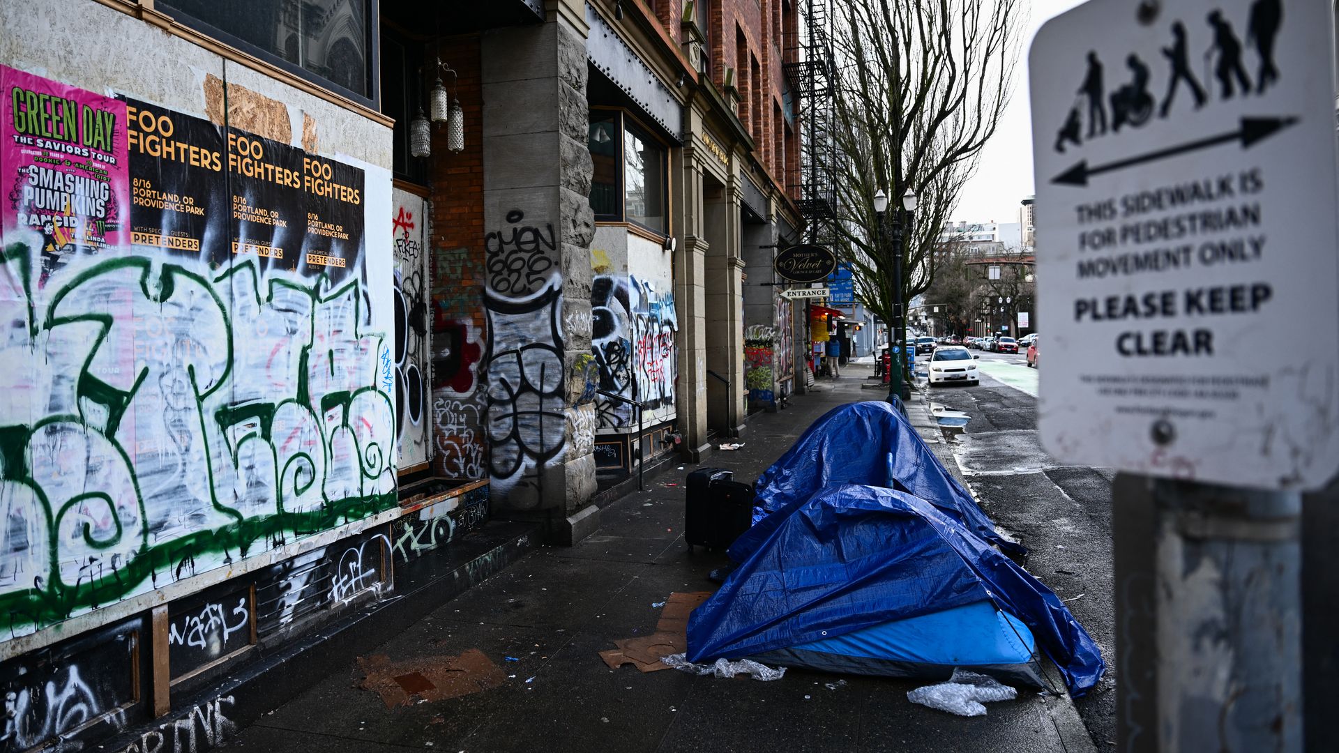 A photo of a blue tent set up on a sidewalk in front of a restaurant.