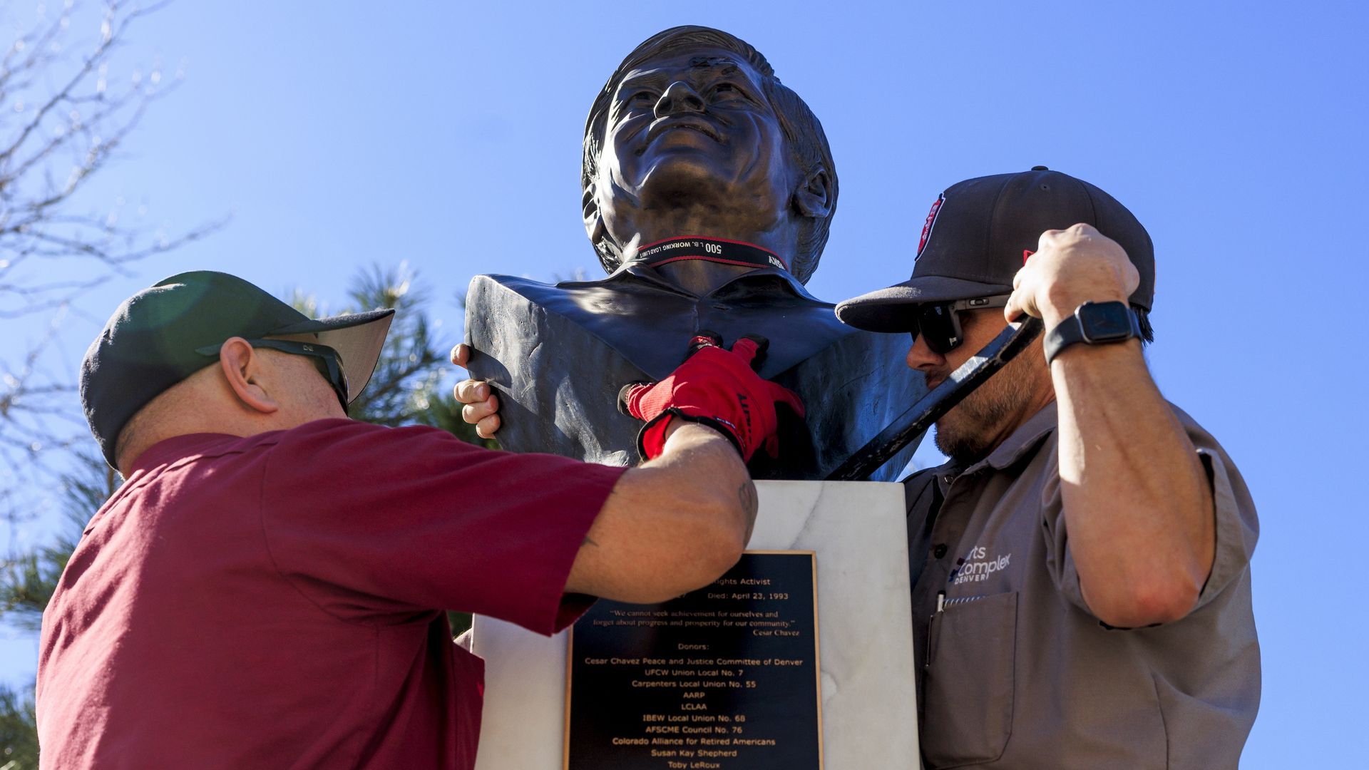Denver Arts and Venues facilities workers remove a bust of Cesar Chavez from Cesar Chavez Park on March 19, 2026, in Denver. Photo: Michael Ciaglo/Getty Images