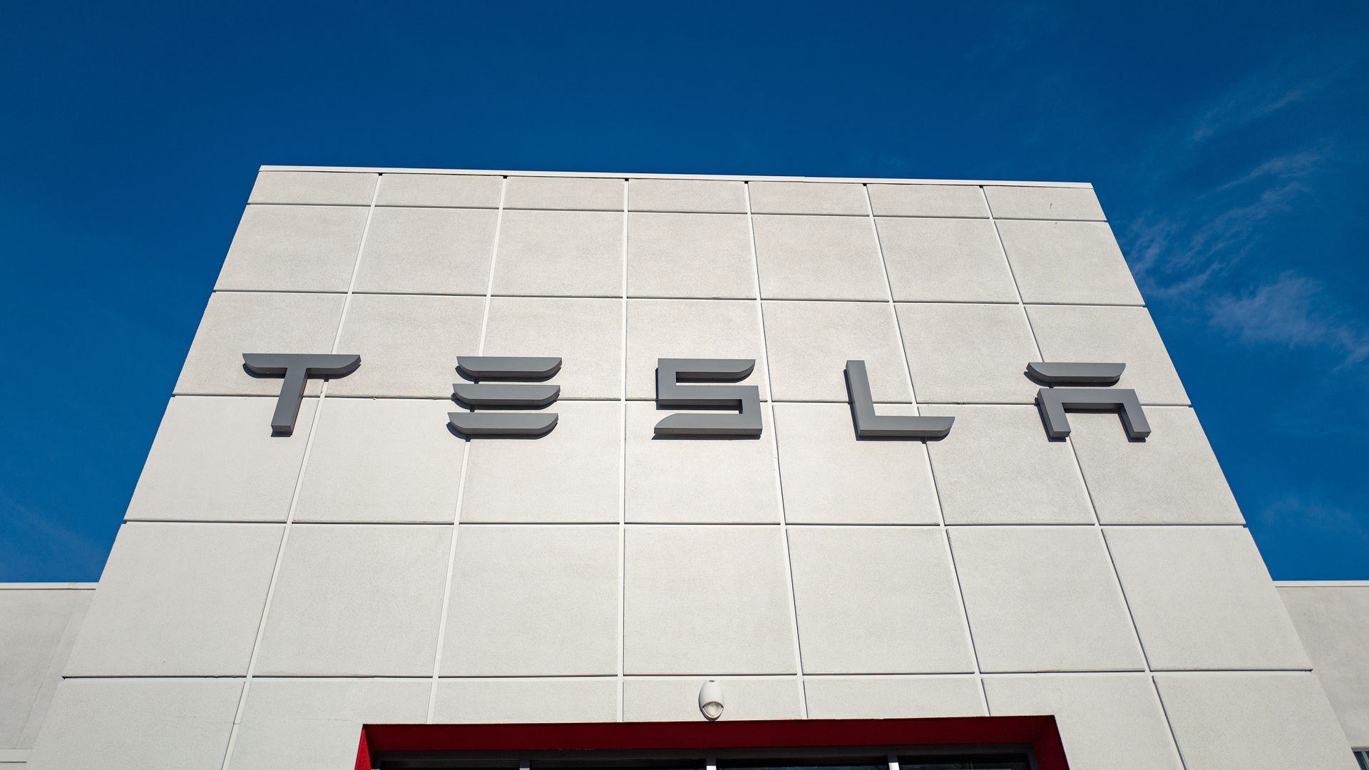 Picture of the facade of Tesla Motors dealership with logo and sign in California