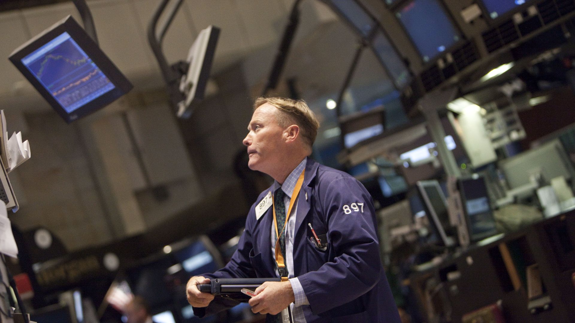 Trader on NYSE looks at monitor.
