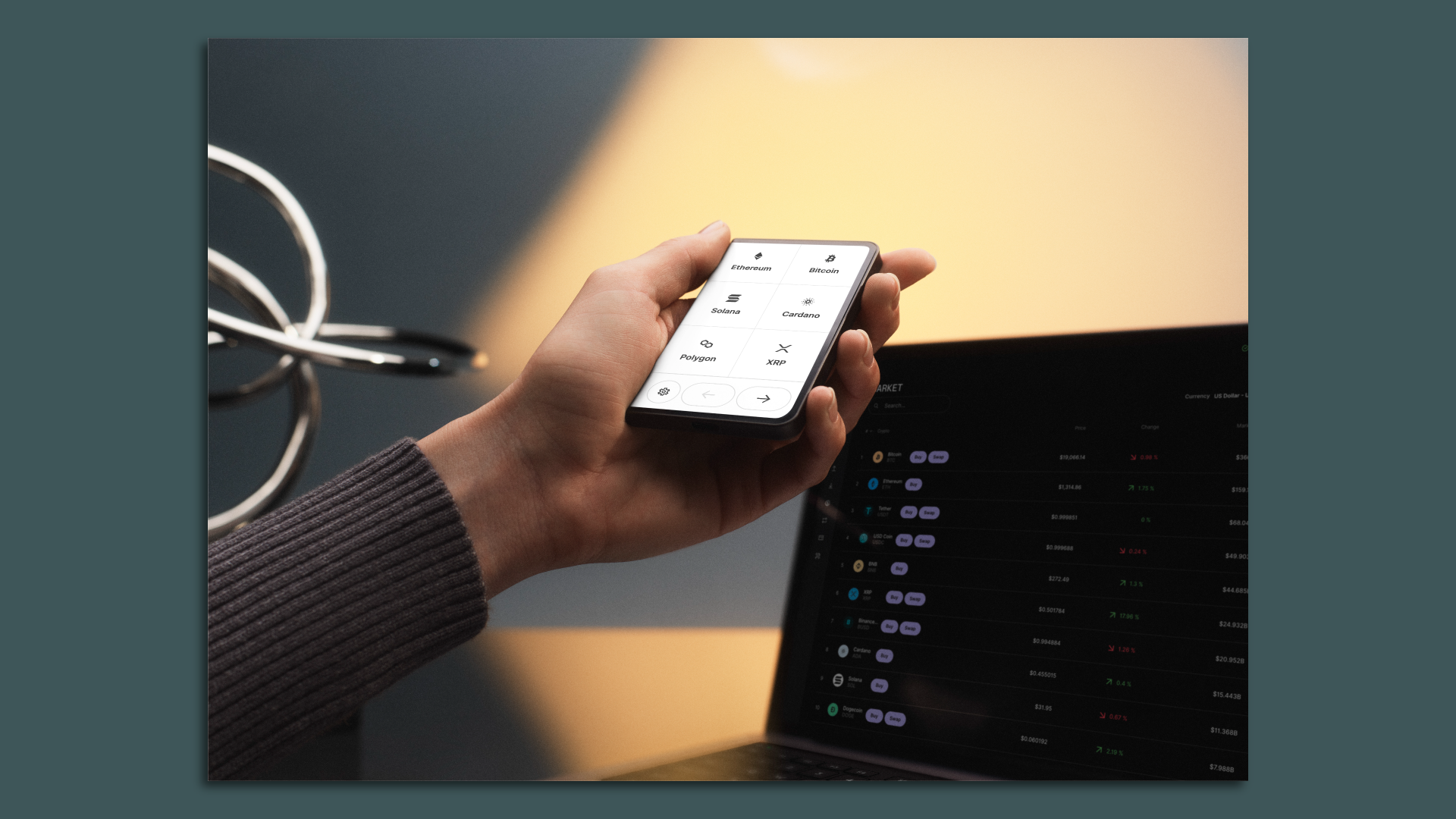 The Ledger Stax, with a computer screen behind it.