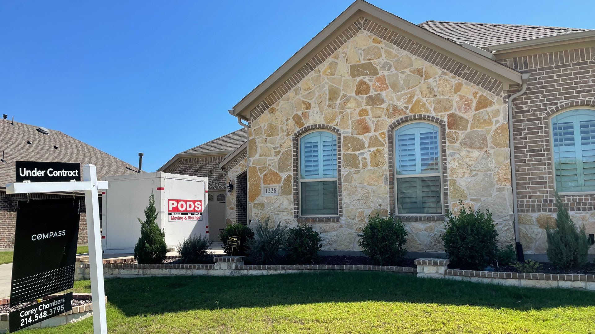 A house with a for sale sign out front