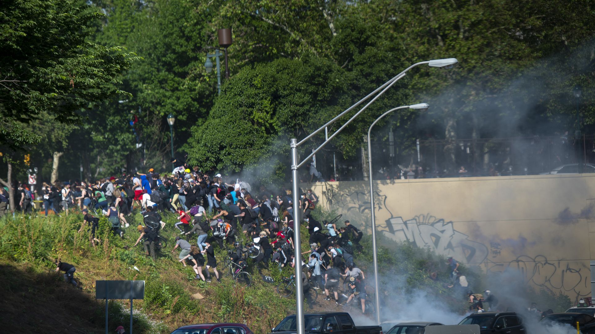 Protesters race up a hill to avoid tear gas in Philadelphia, June 1.