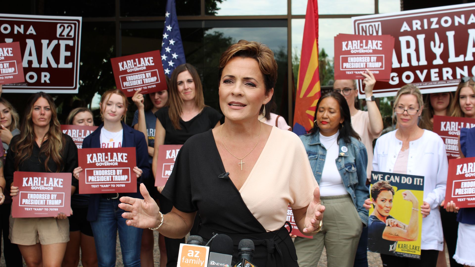 Kari Lake holds her hands out in front of her while speaking to the media at a press conference