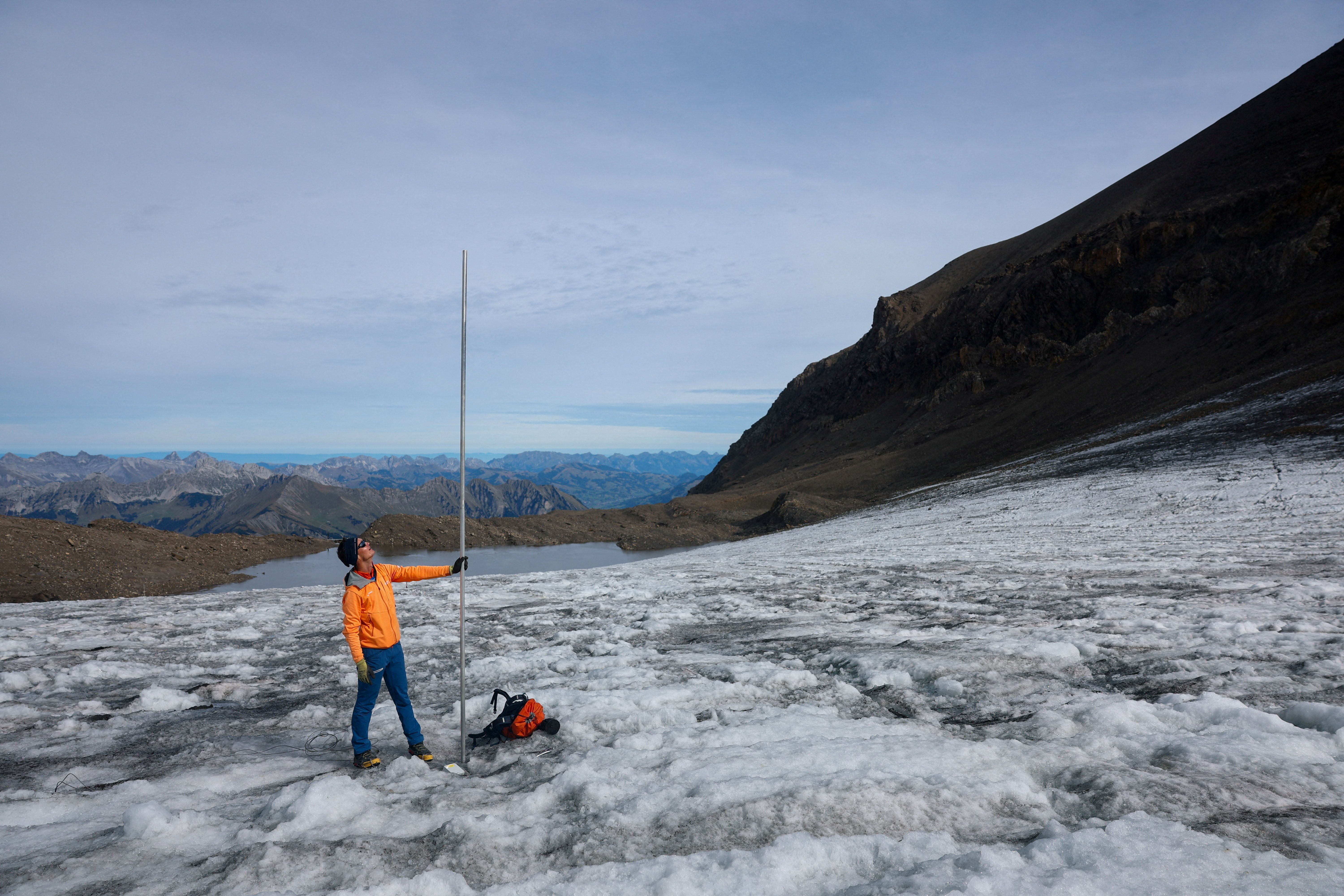 Man stands with a pole in tundra