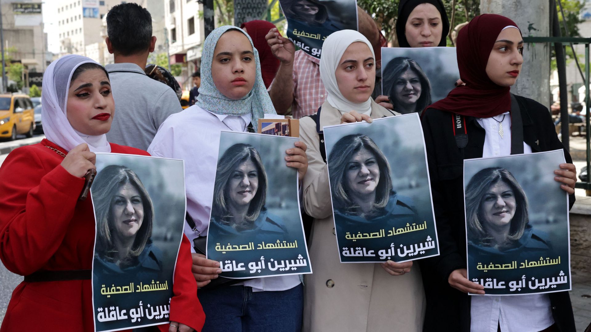 Palestinians hold posters displaying veteran Al Jazeera journalist Shireen Abu Aqleh on May 11 in Hebron.