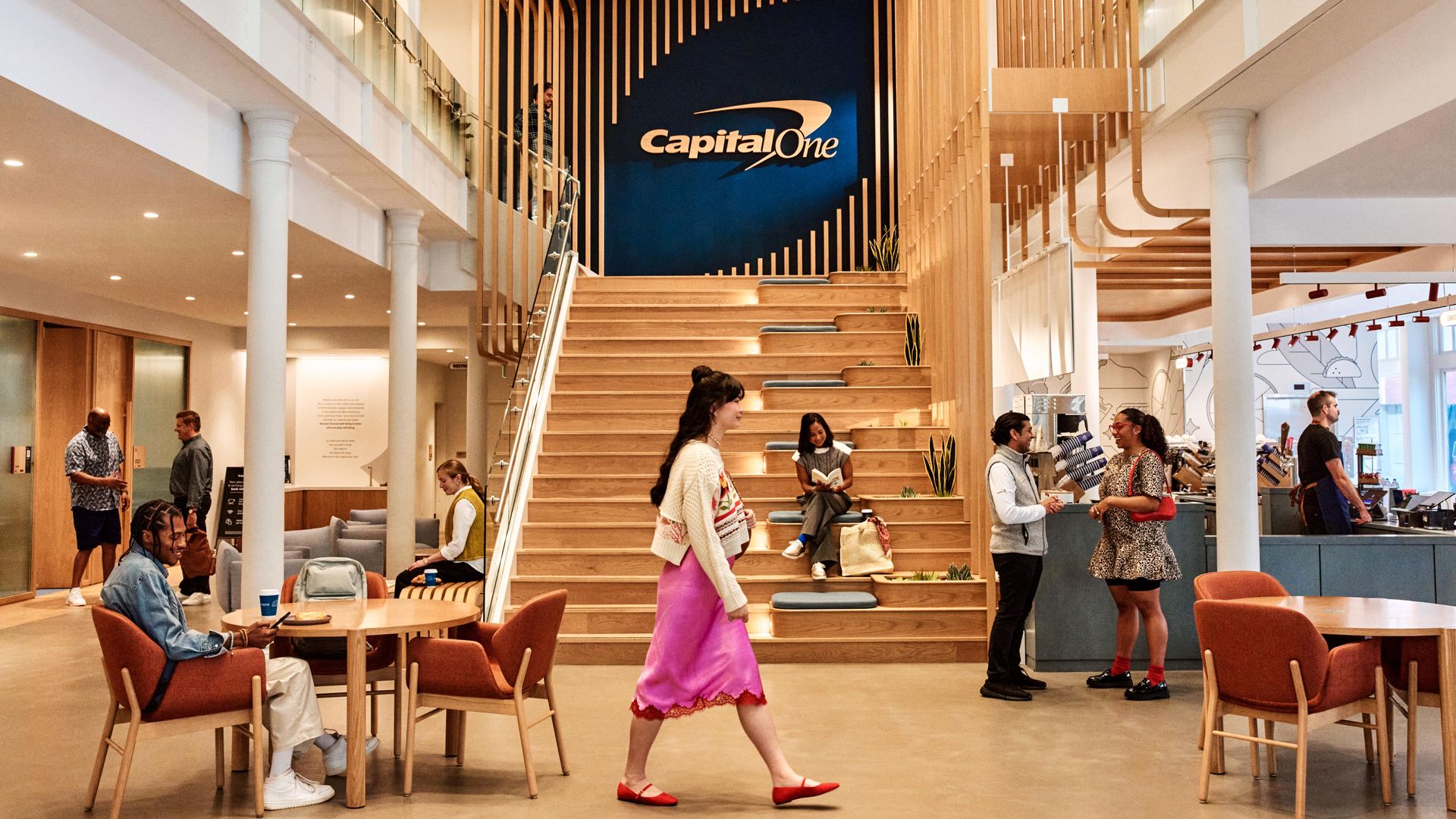 Someone walks through a relatively busy Capital One cafe in Boston's Back Bay.