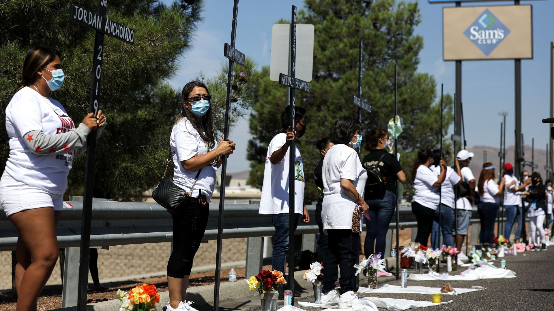 Photo of people holding 23 crosses in honor of those who died during the El Paso shooting in 2019