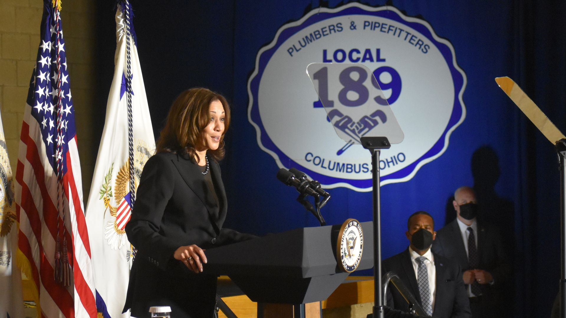 Vice President Kamala Harris speaks at a Columbus union hall with the union's logo on the back wall.