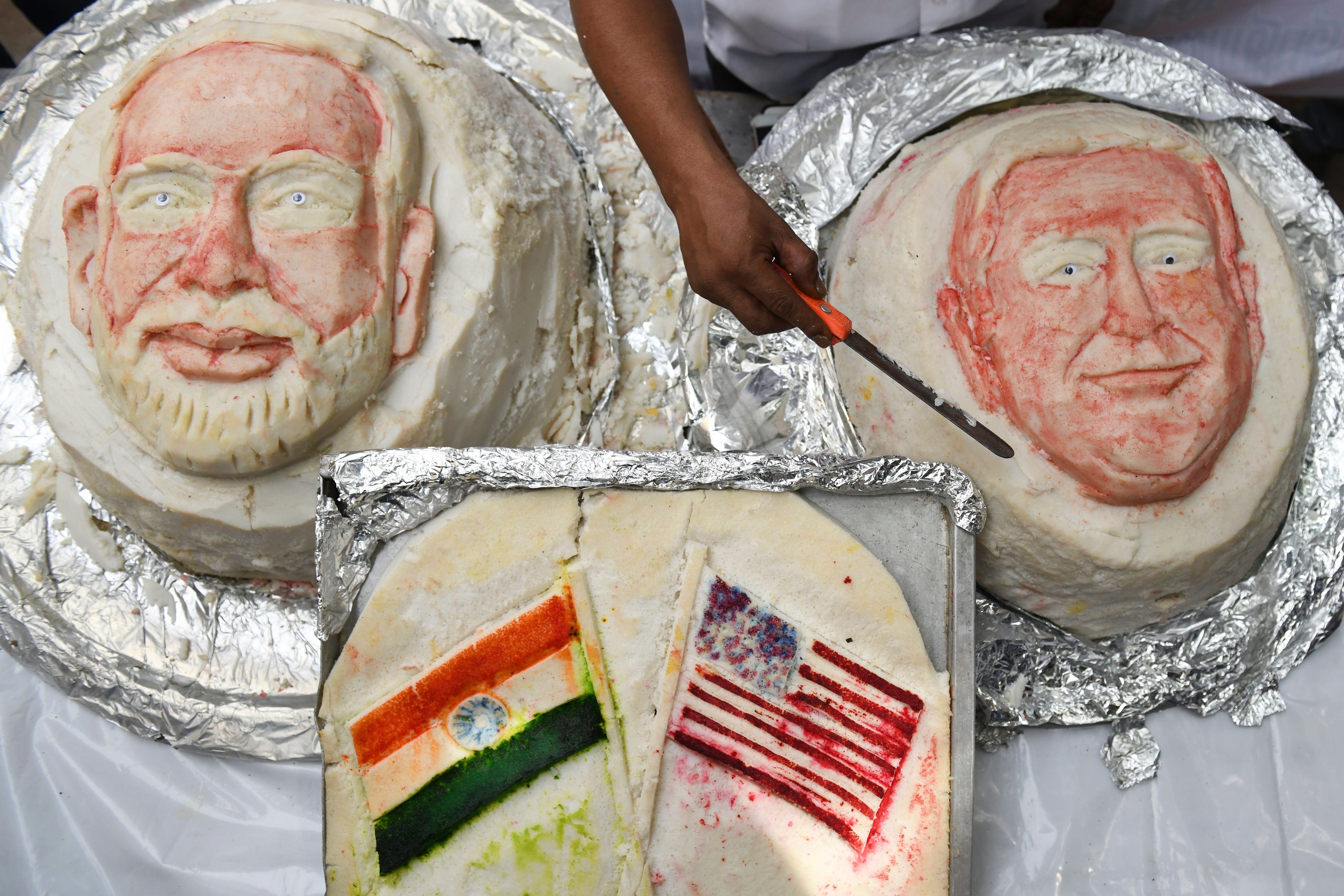 Iniyan, 49, gives final touches to a idili, savoury rice cake, decorated in the shapes of US President Donald Trump and Indian Prime Minister Narendra Modi 