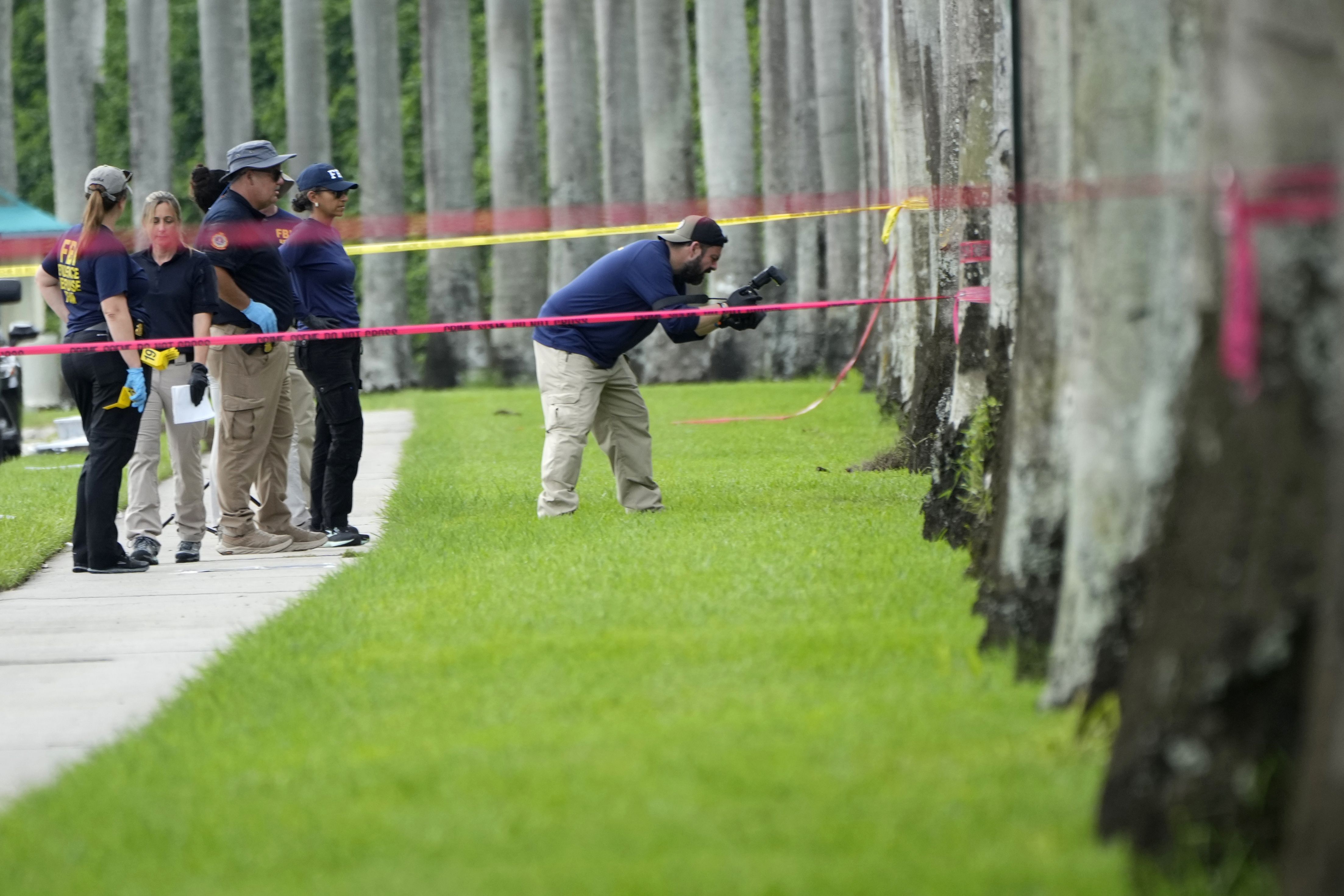 Law enforcement officials work outside of the Trump International Golf Club after the second assassination attempt against the former president.