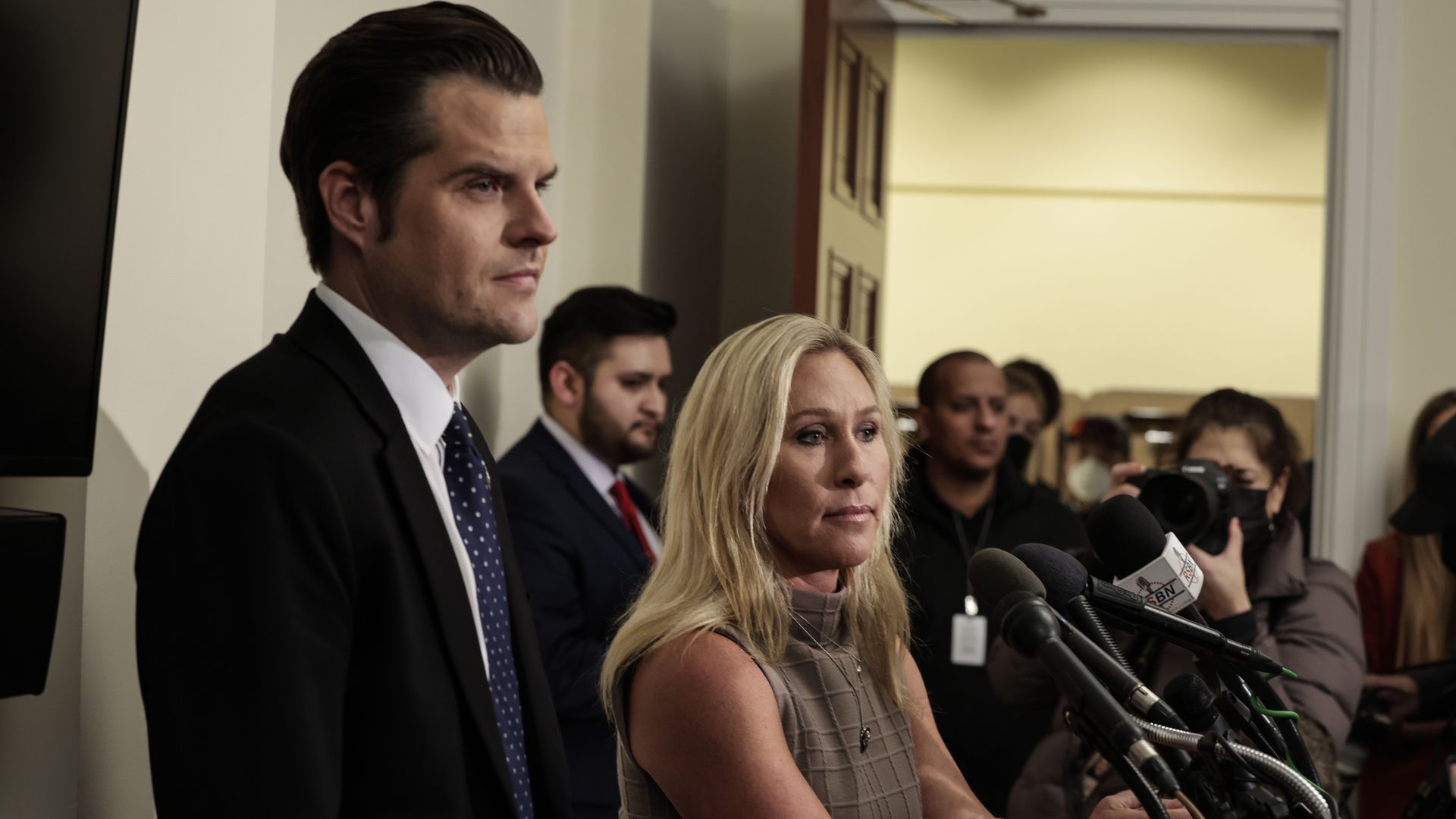 Photo of Matt Gaetz and Marjorie Taylor Greene speaking from a podium