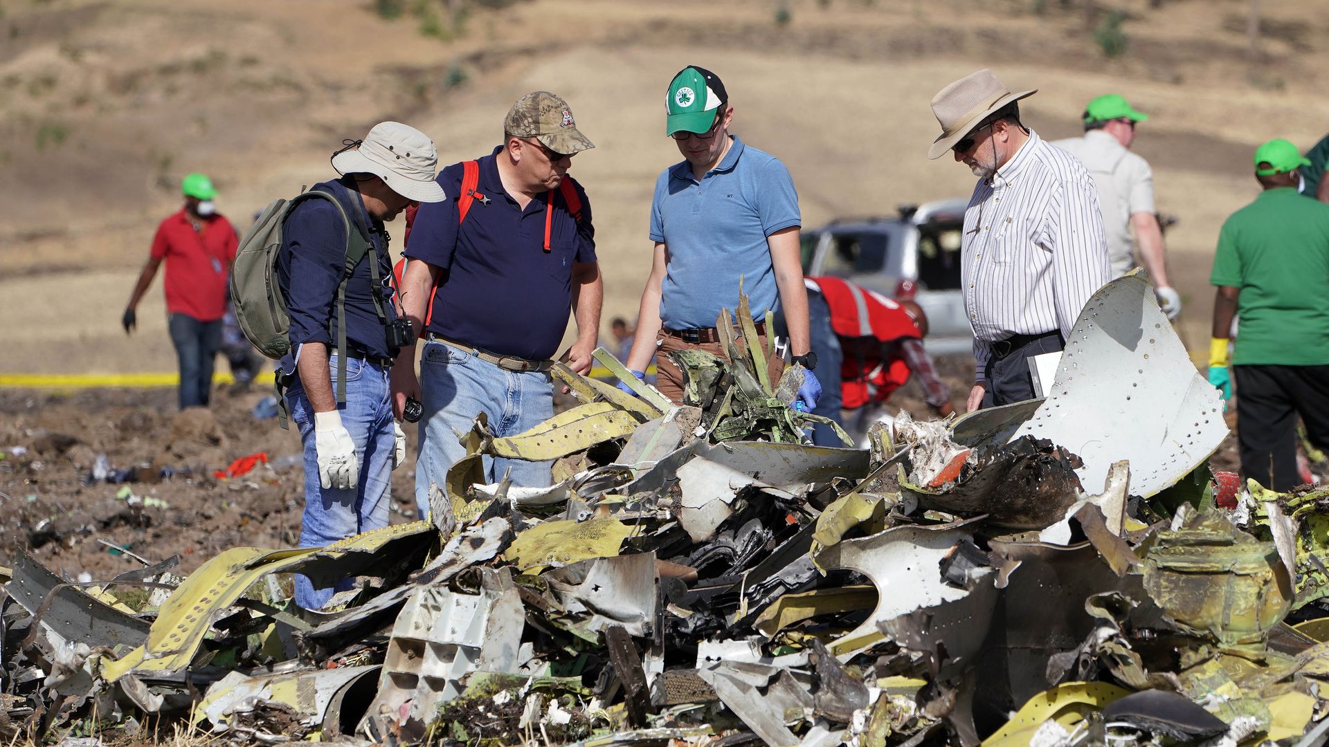 Investigators with the U.S. National Transportation and Safety Board look over debris at the crash site of Ethiopian Airlines Flight ET 302. 