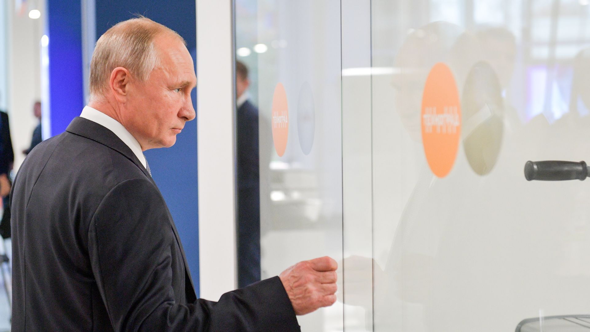 Photo of Vladimir Putin walking into an office