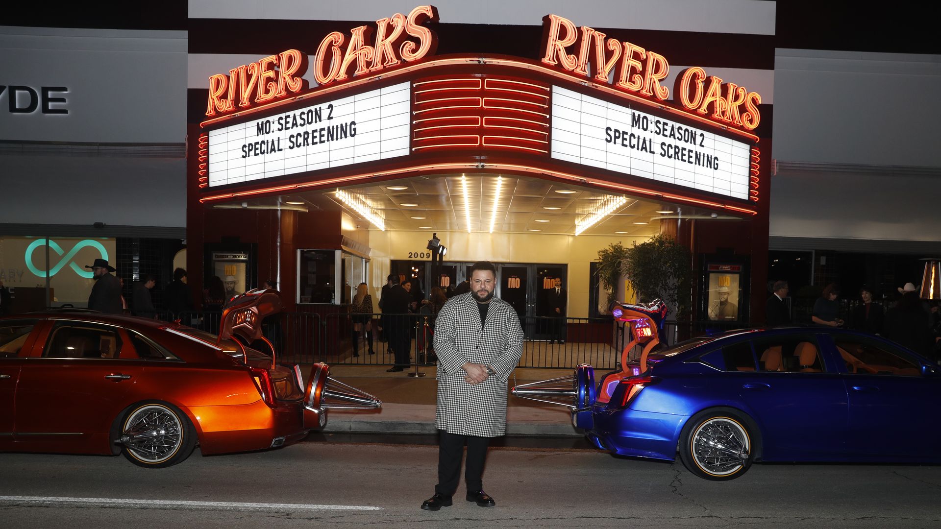 Photo of Mohammed Amer in front of a theater and slabs.