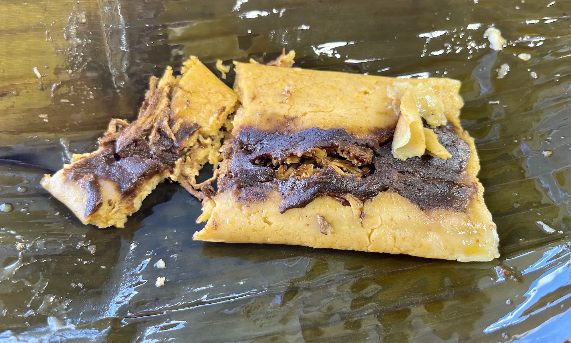 Tamale in an opened banana leaf