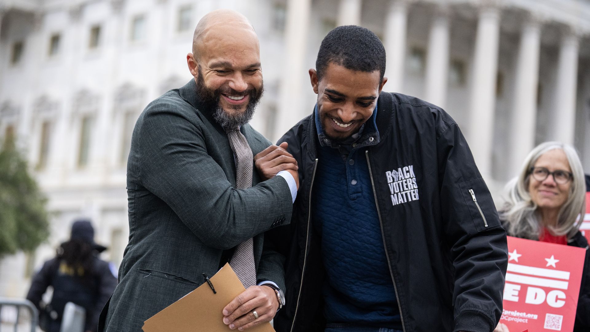 Robert White shakes hands with a statehood supporter