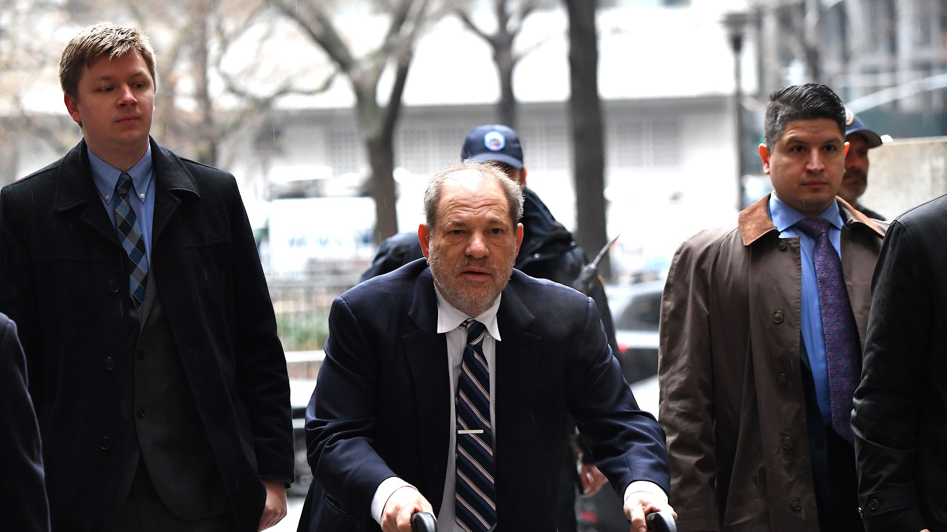 Harvey Weinstein arriving to court with a walking aid