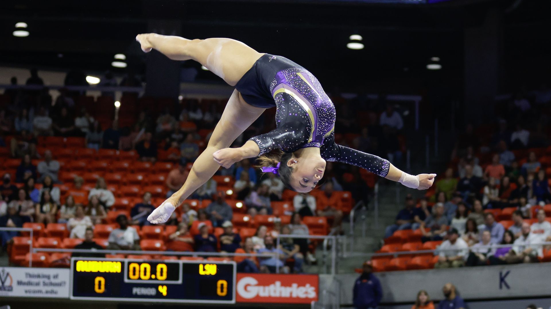 Photo shows a woman doing a flip in the air.