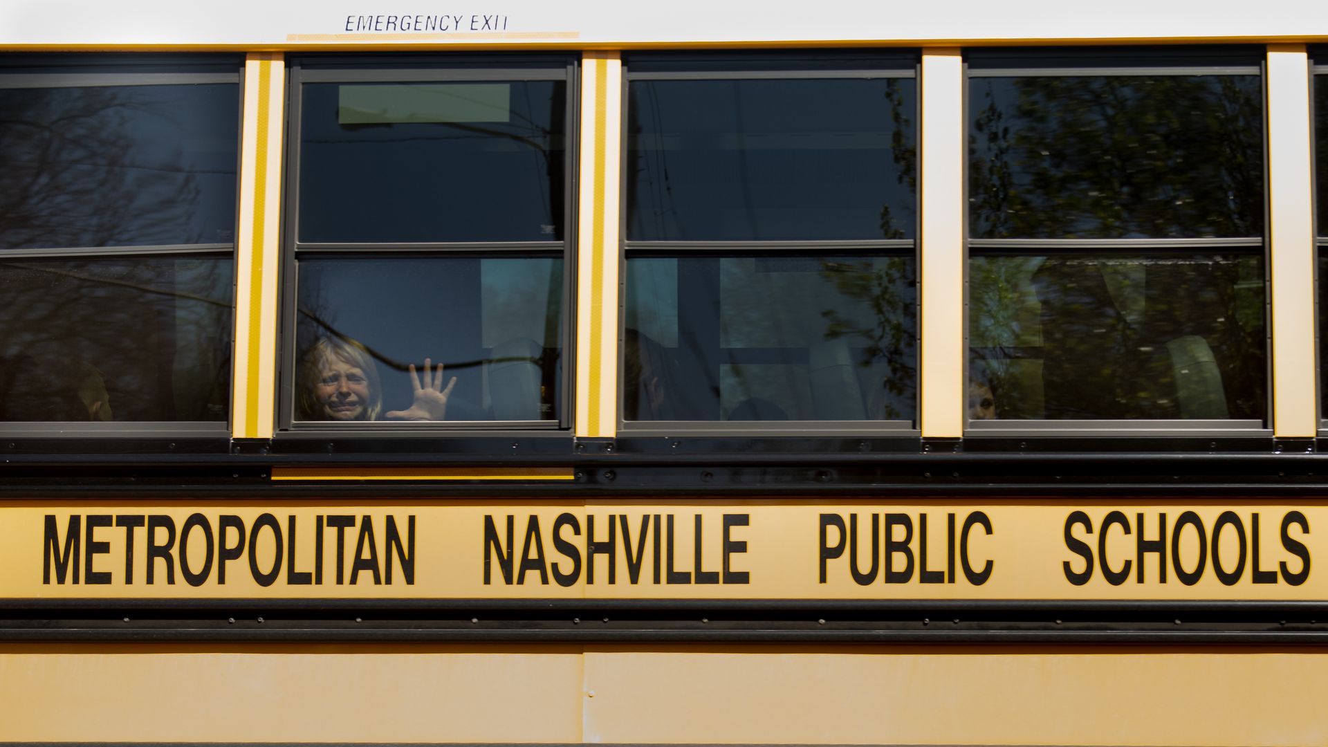 A child weeping on a bus.