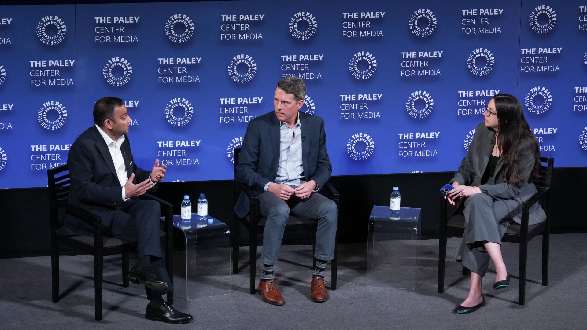 Verizon Consumer Group CEO Sowmyanarayan Sampath, Warner Bros. Discovery Chief Revenue and Strategy Officer Bruce Campbell and Axios' Kerry Flynn seated in chairs on a stage with a background that says The Paley Center for Media 