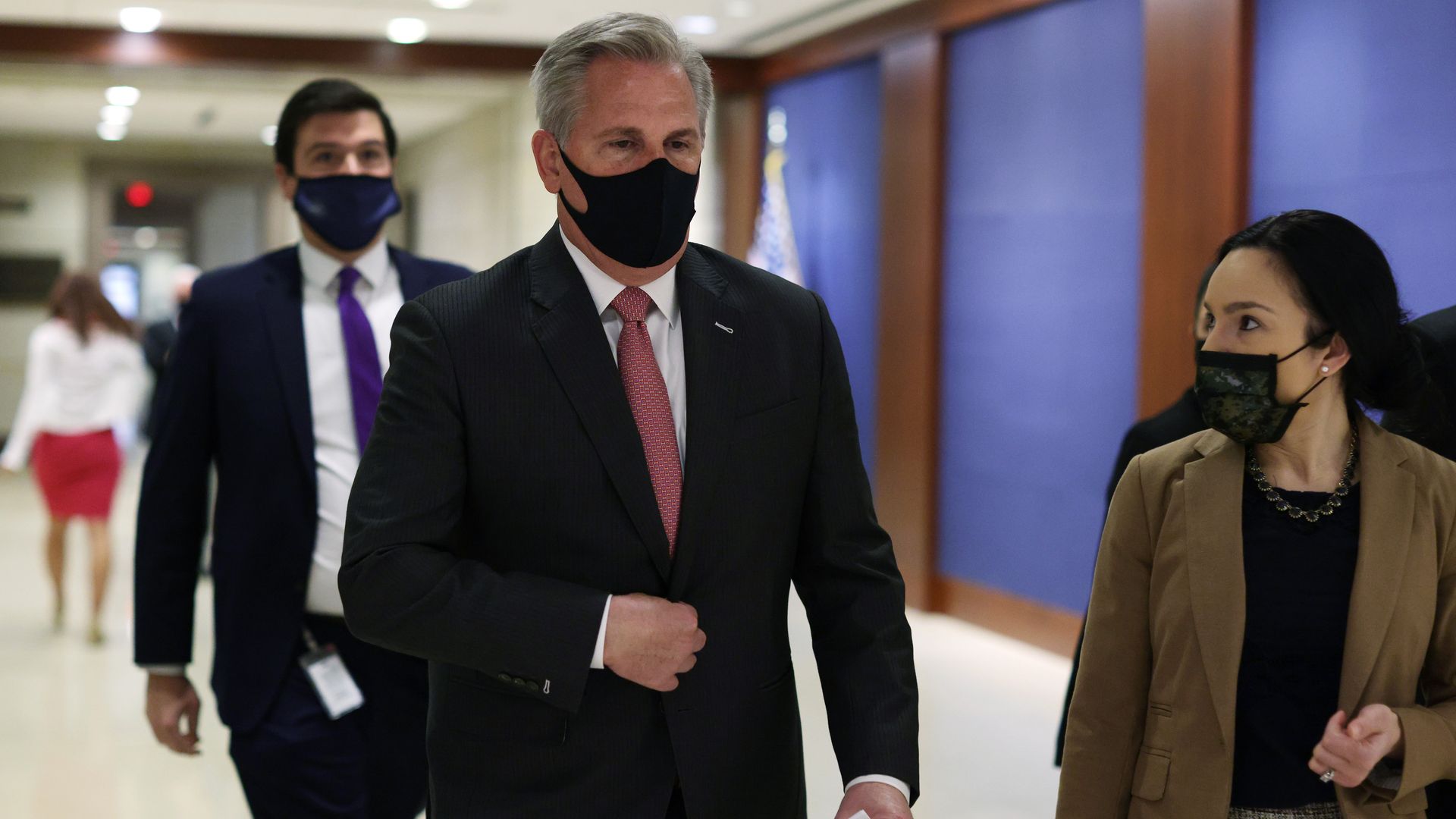 House Minority Leader Kevin McCarthy is seen walking down a hall.