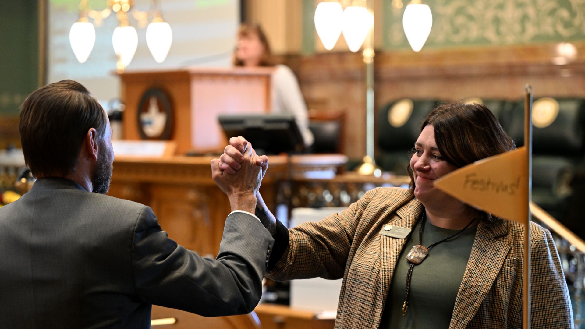 State Reps. Chris deGruy Kennedy, left, and Jenny Willford, right, shake hands as a bill passes on the final day of the legislative session Wednesday. Photo: Helen H. Richardson/Denver Post via Getty Images