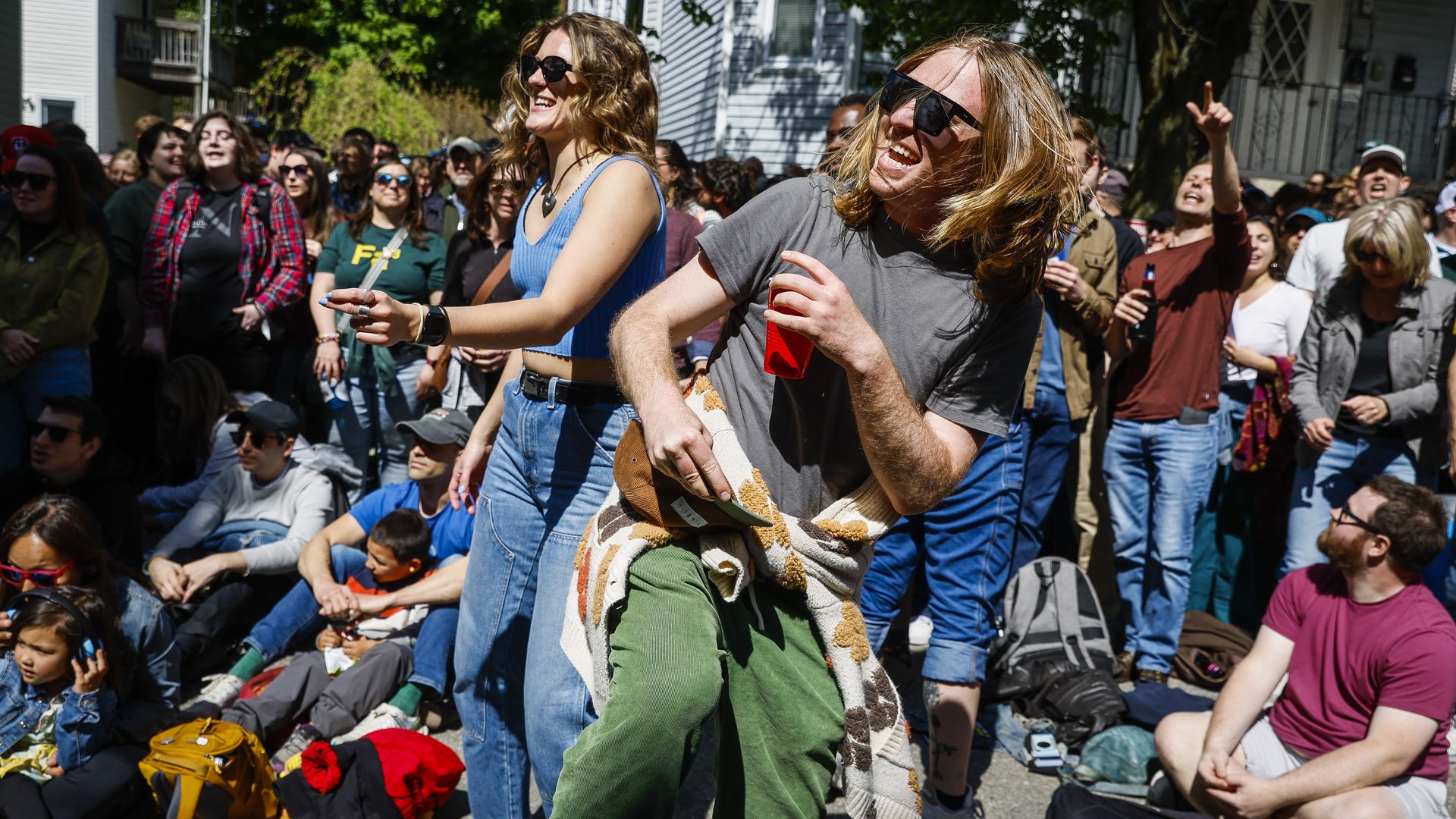 People dance to rock cover band Mixtape Misfits while attending Somerville Porchfest in 2024.