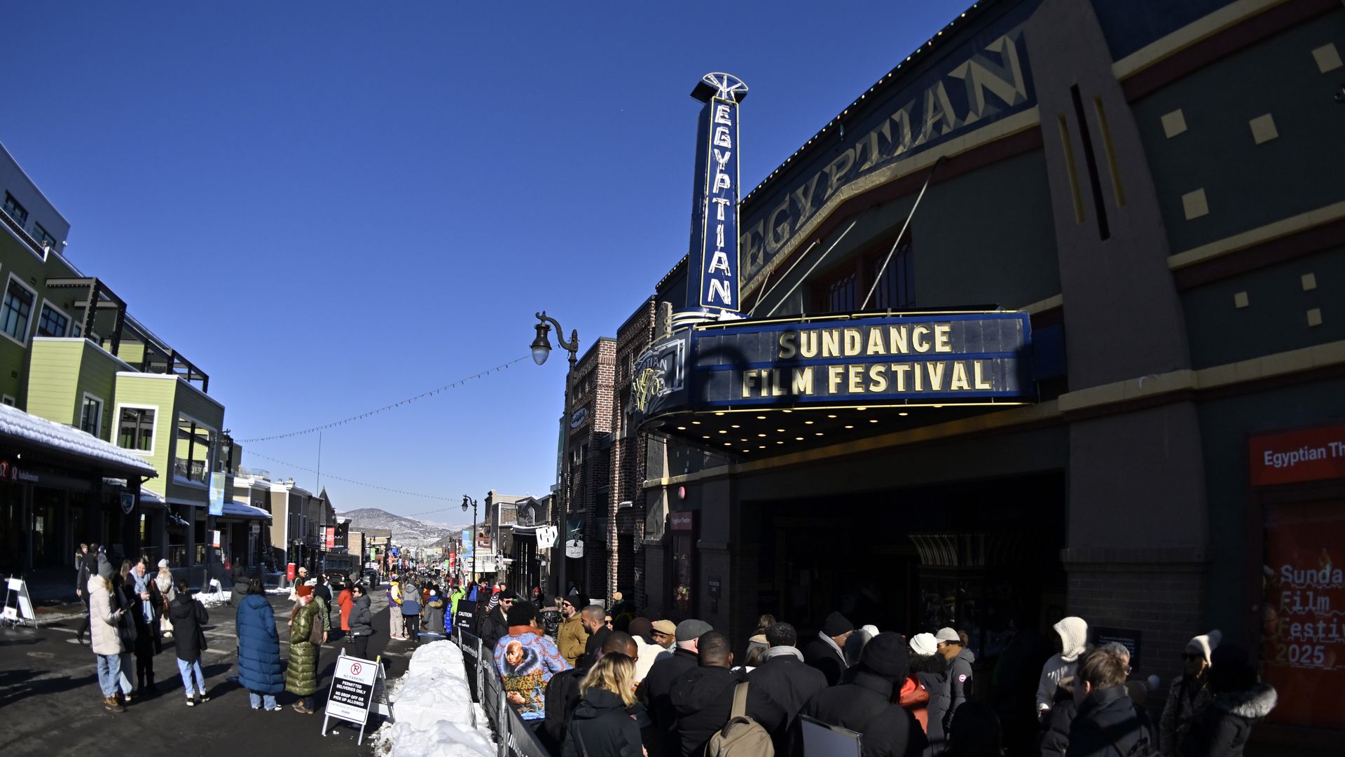 People stand in front of the Egyptian Theatre along Main Street during the 2025 Sundance Film Festival on January 27, 2025 in Park City, Utah. 