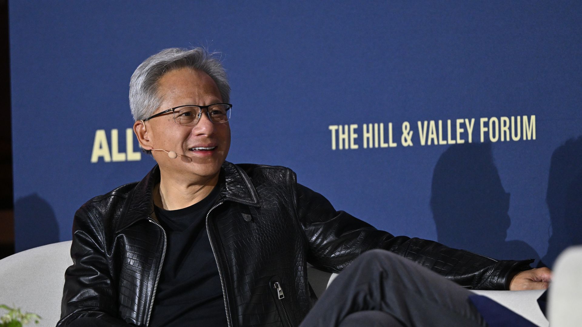 Nvidia CEO Jensen Huang speaking on a stage.