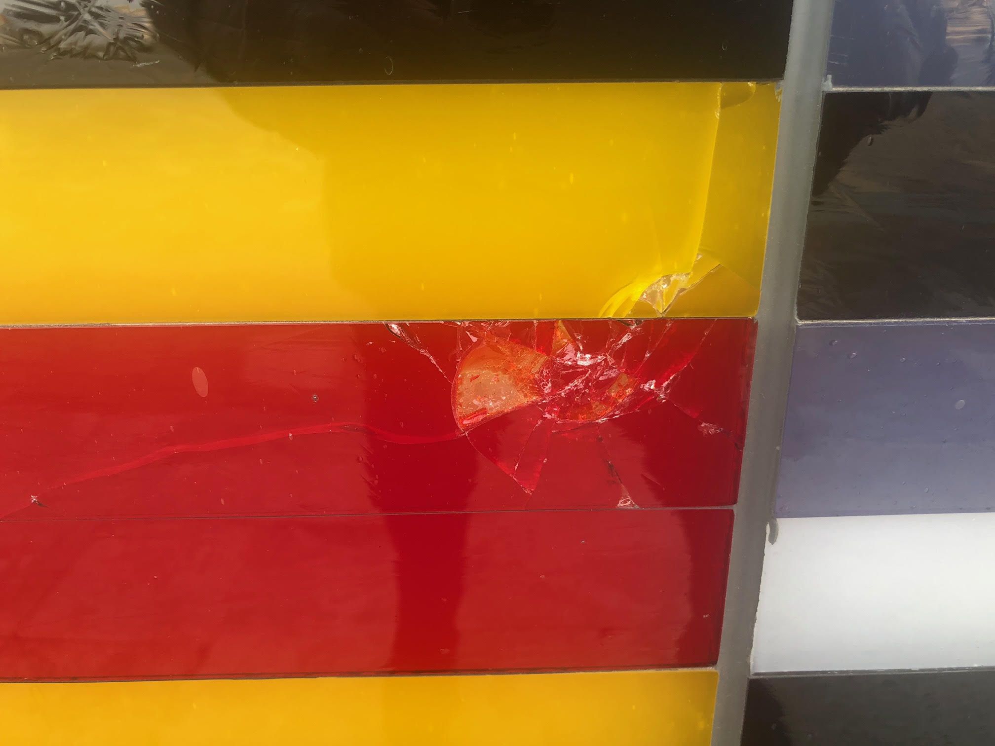 A photo of damage to a glass mural.