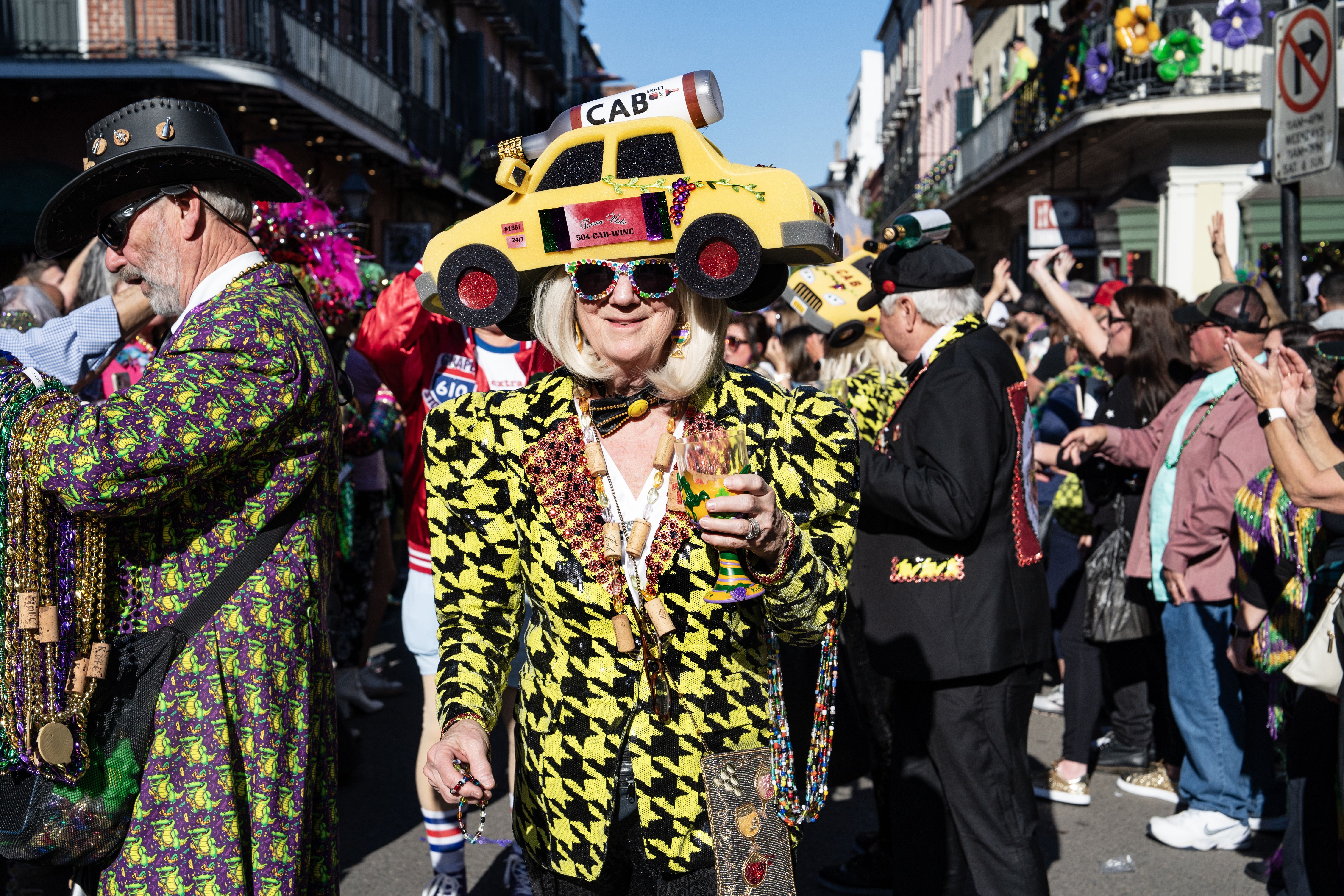 A parade reveler dressed like a taxi cab/cabernet mashup.