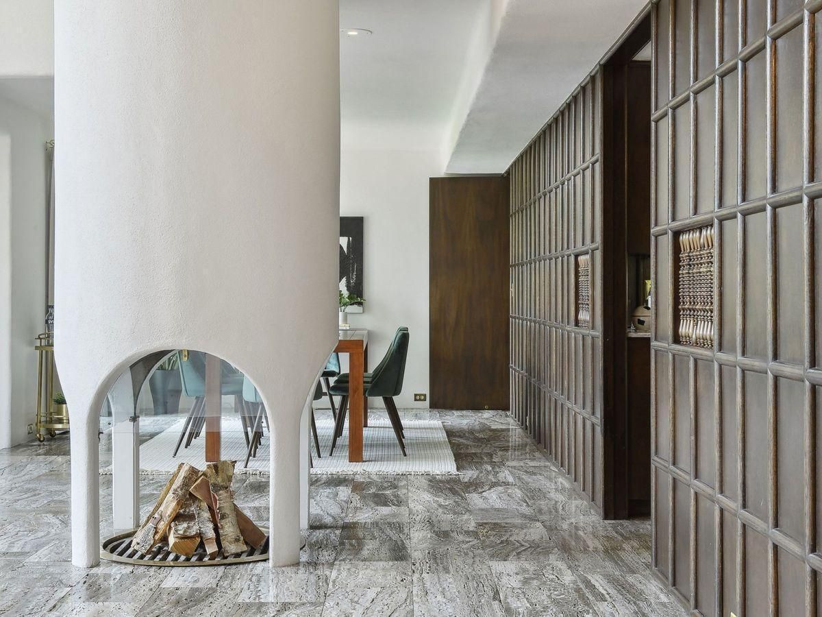 cylinder arched fireplace with view of dining room