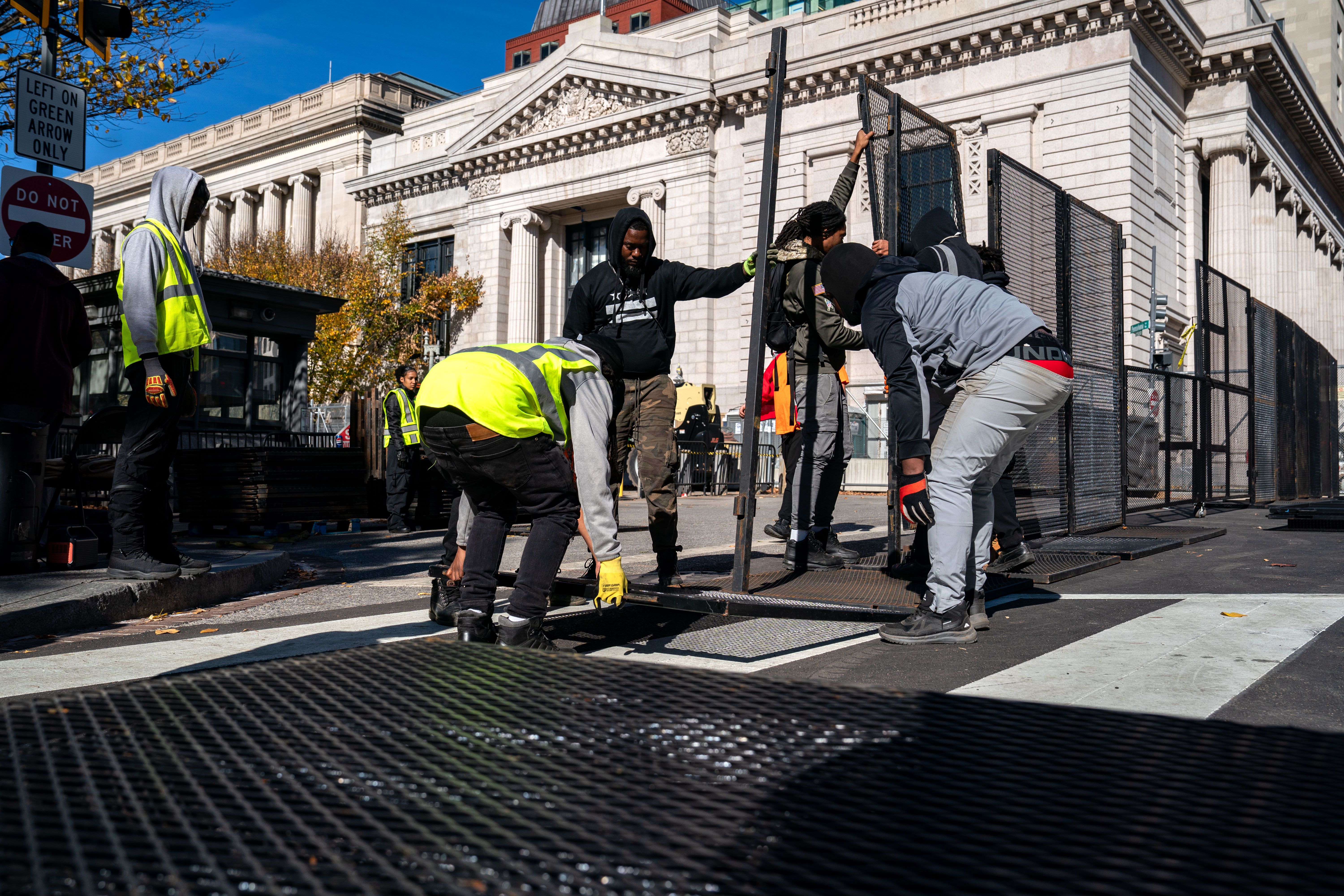 Workers erect anti-scale fencing around the White House and the Treasury Department along 15th St NW on November 03, 2024 in Washington, DC.