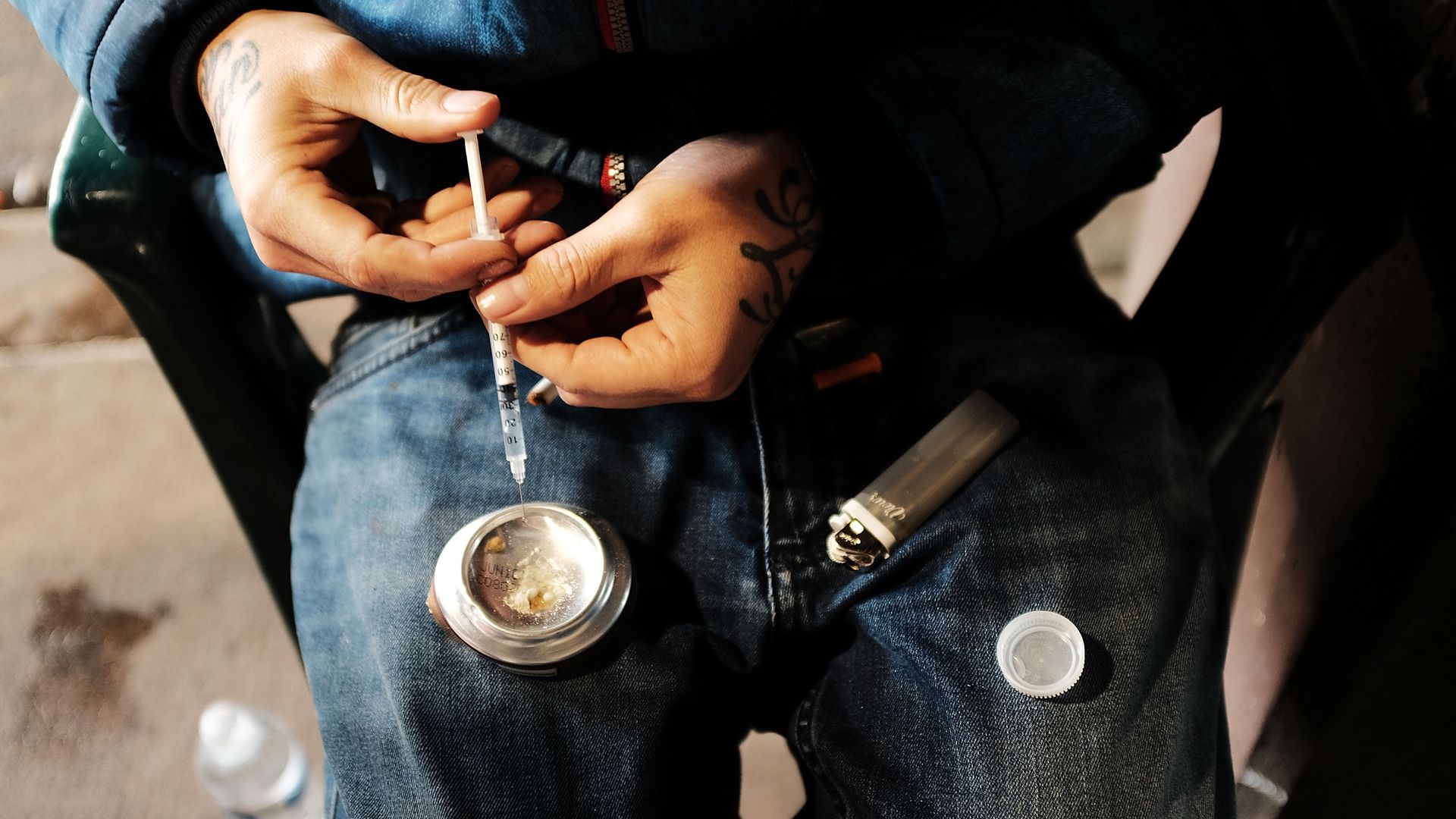 A man uses heroin.