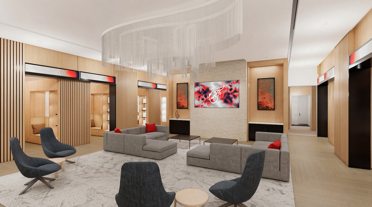 Contemporary hotel lobby with light wood panel walls, gray sofas, and navy chairs. A circular chandelier hangs over a pale rug; a textured white brick wall displays a red-blue abstract artwork and a screen.