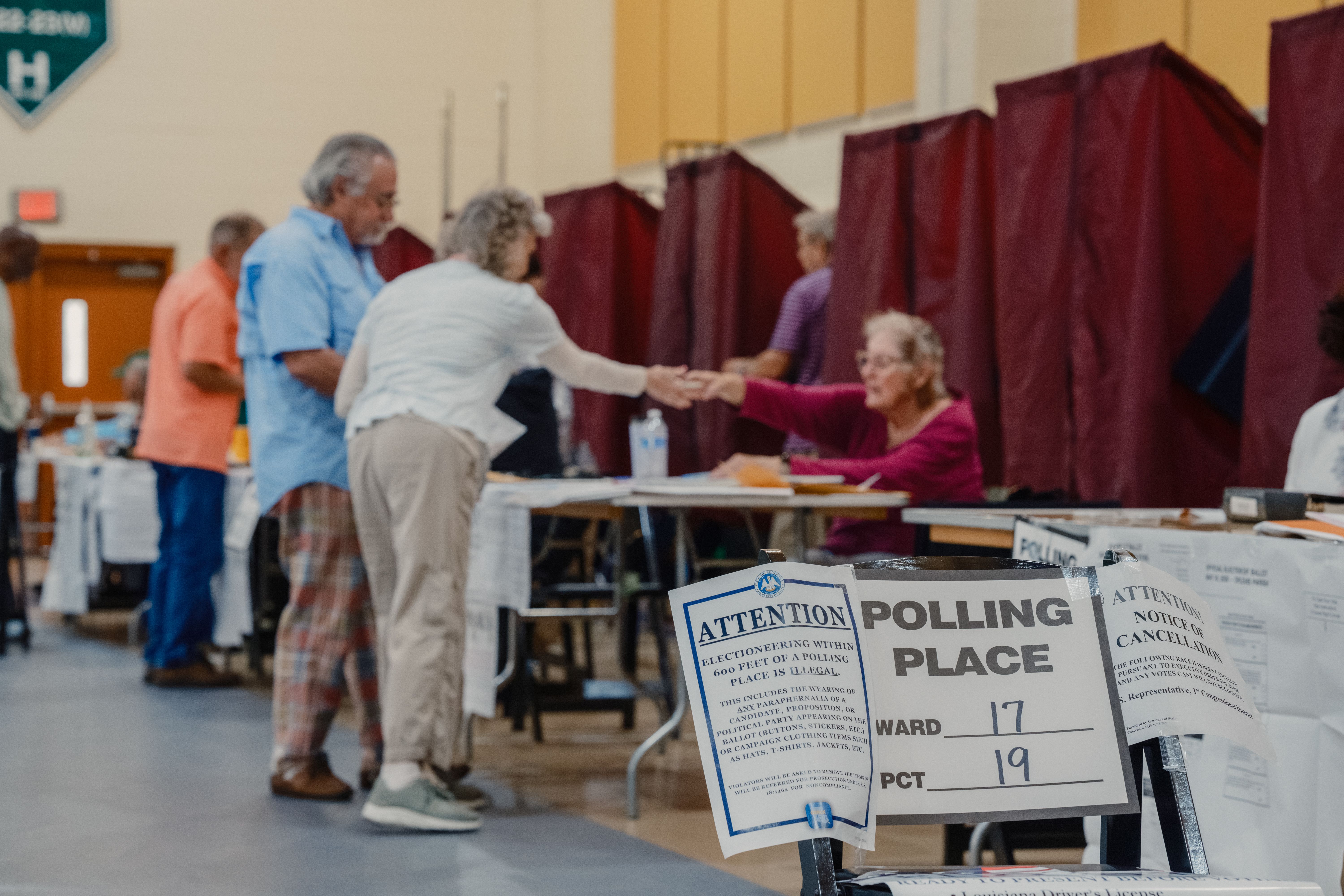 Image shows people at a polling place.