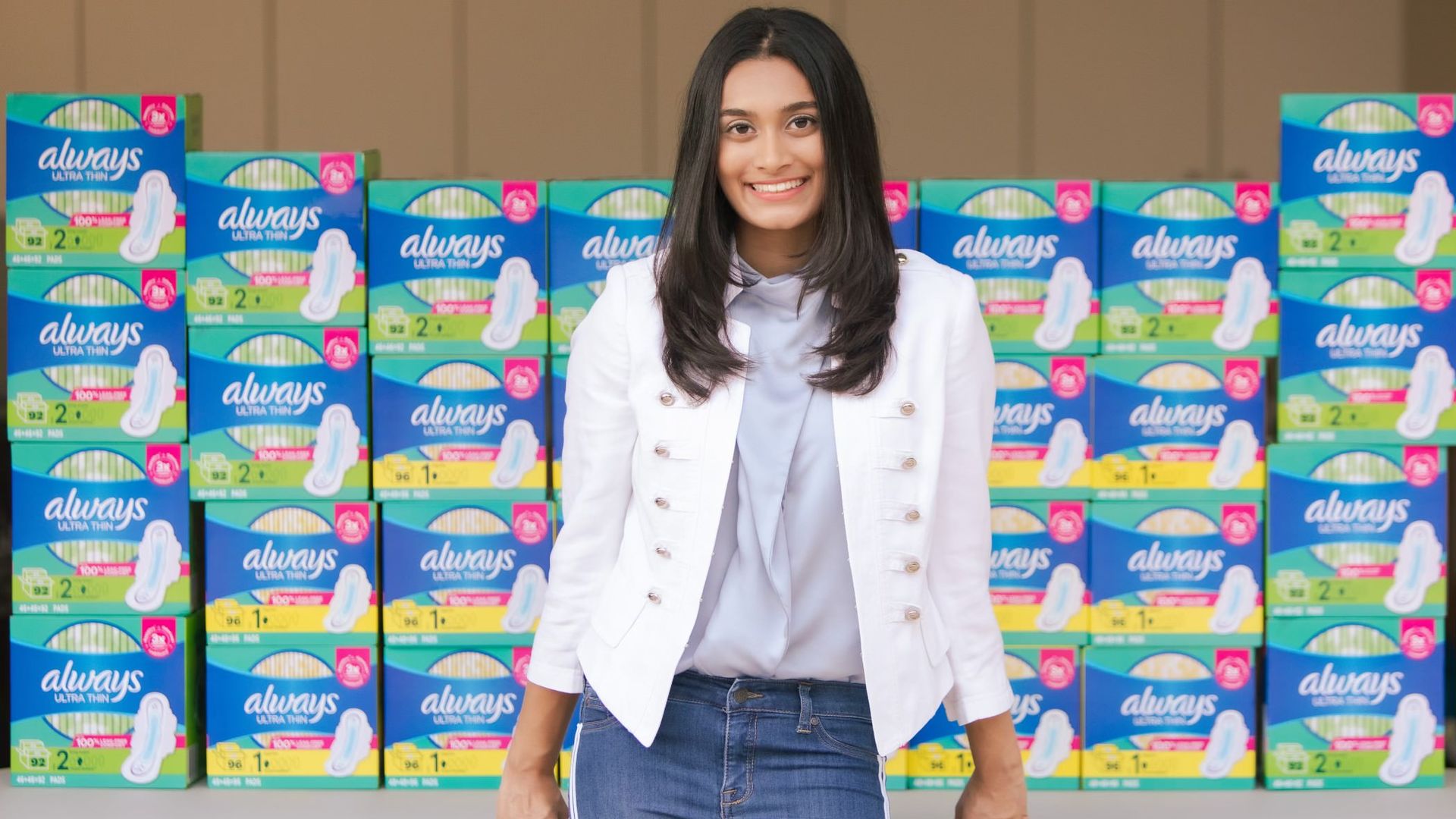 Aanya patel in front of stacks of Always pads boxes