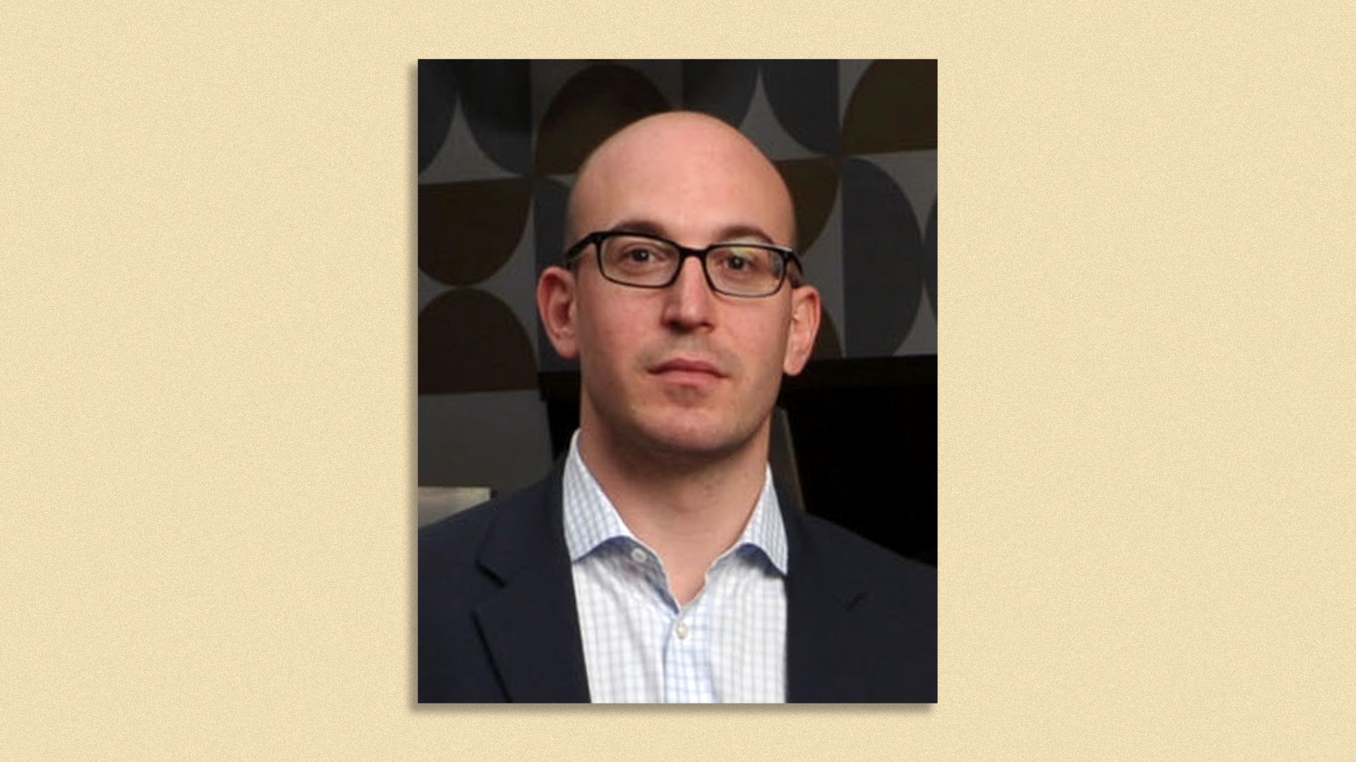 Photo of Ophir Lupu wearing a suit and eyeglasses