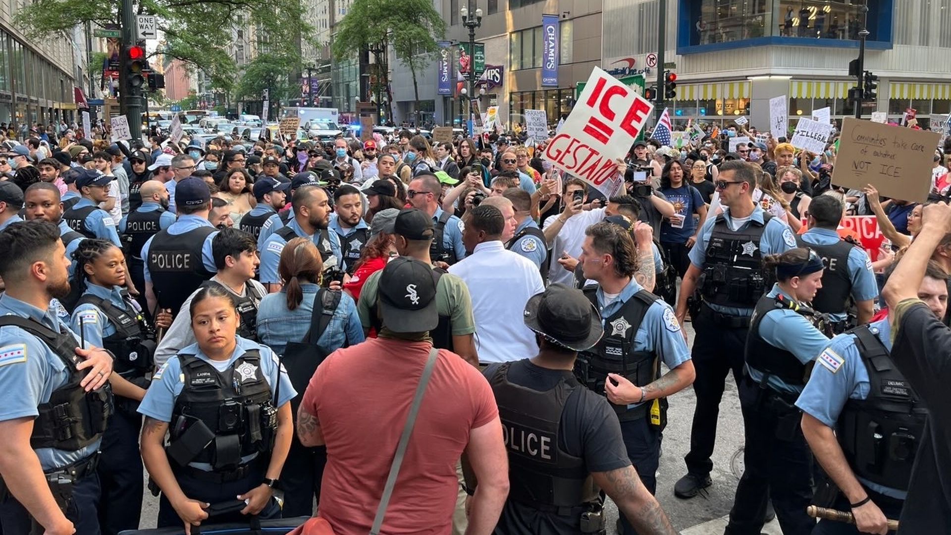 Photo of police and protesters meeting in the middle of a street. 