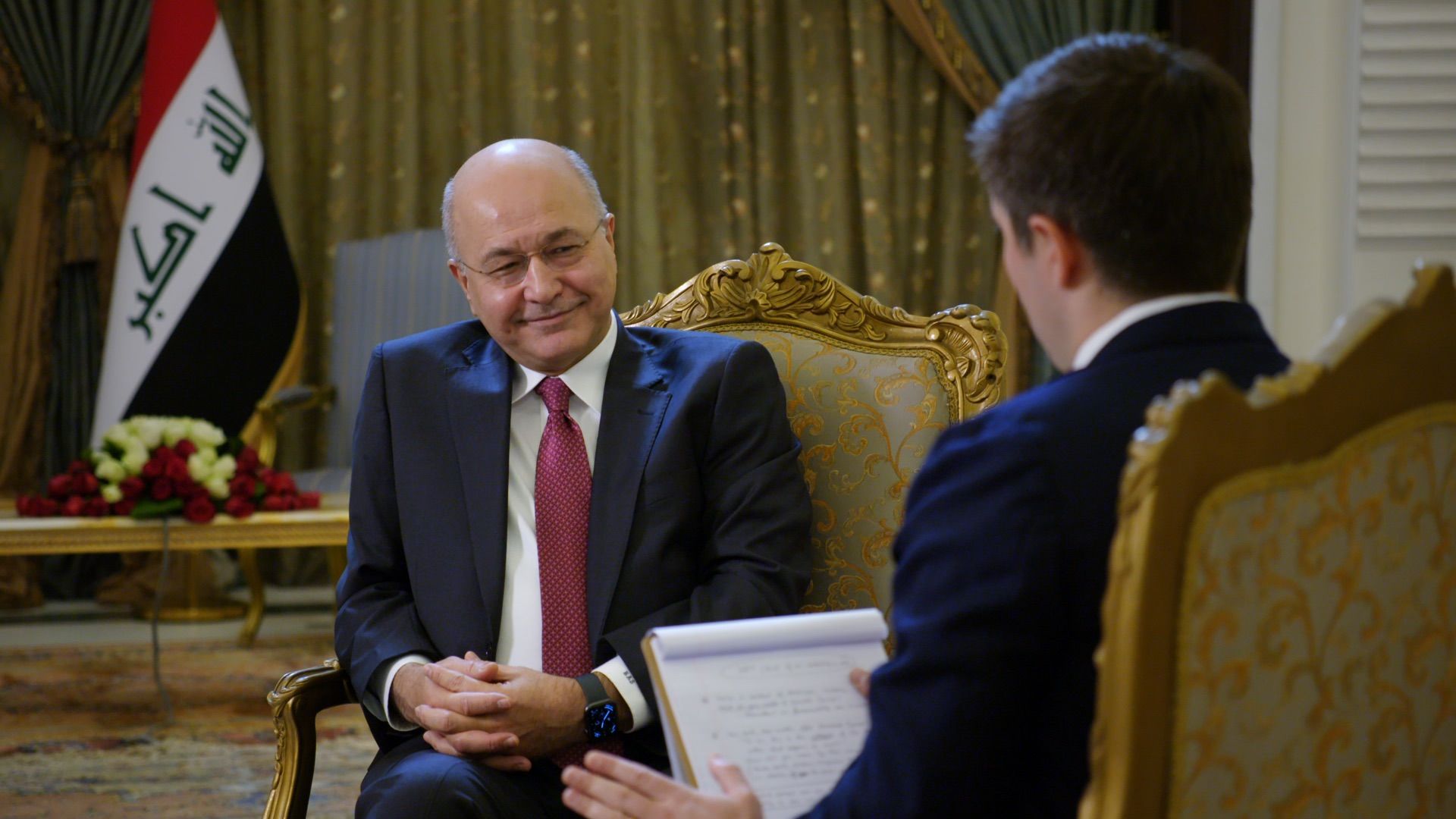 Iraqi President Barham Salih smiles as he gives an interview