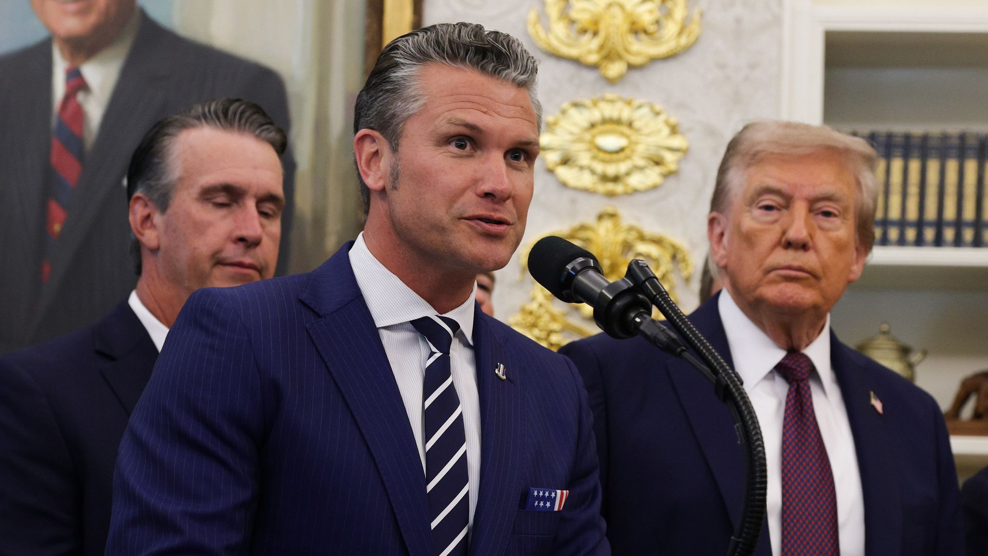 Defense Secretary Pete Hegseth speaks as President Trump looks on in the Oval Office on Sept. 2.