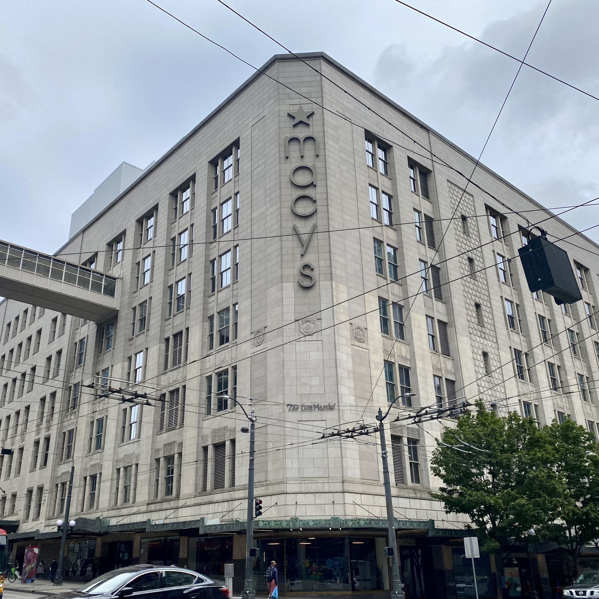 A grey building with letters spelling "Macy's" displayed vertically on the building corner.