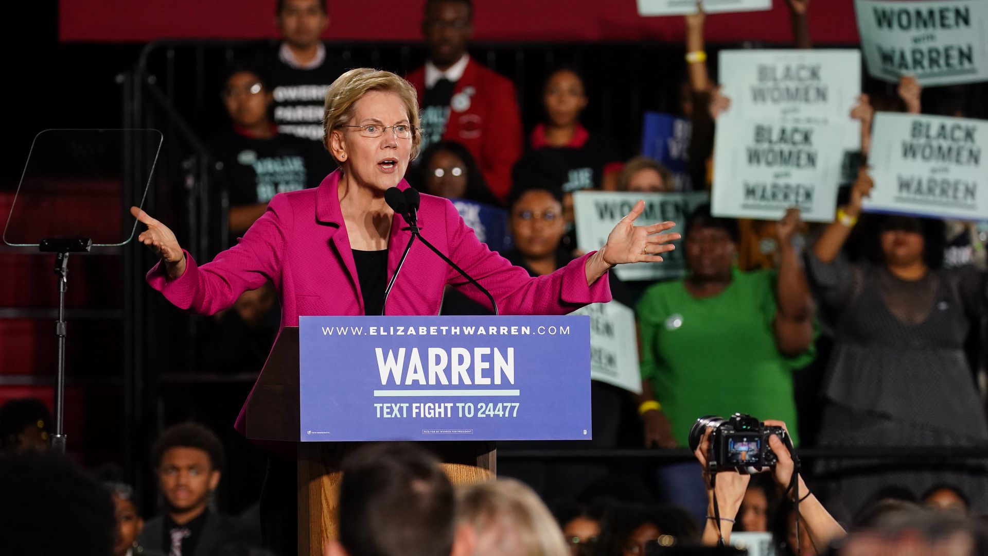 Elizabeth Warren speaks at a podium.